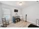 Cozy bedroom with light wood floors and bright light from the window with light-filtering blinds at 30918 Burleigh Dr, Wesley Chapel, FL 33543