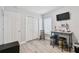 Bright bedroom with light wood floors and bright light from the window with light-filtering blinds at 30918 Burleigh Dr, Wesley Chapel, FL 33543