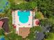Aerial view of community pool, surrounded by seating, playgrounds, and other recreational features at 30918 Burleigh Dr, Wesley Chapel, FL 33543