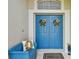 Inviting double front doors with sunflower decor, a matching bench, and a 'Welcome' mat at 30918 Burleigh Dr, Wesley Chapel, FL 33543