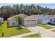 Charming single-story home boasts a well-manicured lawn, mature landscaping and an attached two car garage at 30918 Burleigh Dr, Wesley Chapel, FL 33543