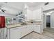 Bright kitchen boasts white cabinets, granite counters, mosaic backsplash, and stainless steel appliances at 30918 Burleigh Dr, Wesley Chapel, FL 33543