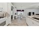 Open kitchen with white cabinets, granite counters, and seamless transition into the living area at 30918 Burleigh Dr, Wesley Chapel, FL 33543