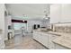 Updated kitchen featuring sleek white cabinetry, granite countertops, and views into the living area at 30918 Burleigh Dr, Wesley Chapel, FL 33543