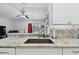 Granite countertops paired with mosaic backsplash in the kitchen, opening up into the living area at 30918 Burleigh Dr, Wesley Chapel, FL 33543