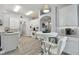 Bright, white kitchen featuring an eat-in area, modern appliances, and stylish tile backsplash at 30918 Burleigh Dr, Wesley Chapel, FL 33543