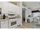 Modern kitchen with white cabinets, granite countertops, a gas range, and stainless steel microwave at 30918 Burleigh Dr, Wesley Chapel, FL 33543
