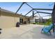 Expansive screened lanai with a view of the beautifully landscaped backyard with mature trees at 30918 Burleigh Dr, Wesley Chapel, FL 33543