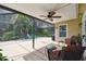 Spacious screened lanai with comfortable seating and a serene view of the lush, landscaped backyard at 30918 Burleigh Dr, Wesley Chapel, FL 33543