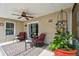 Relaxing covered lanai with ceiling fan, wicker furniture, and view of the serene backyard at 30918 Burleigh Dr, Wesley Chapel, FL 33543