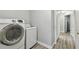 Efficient laundry room featuring a modern washer and dryer set and a clean, organized space at 30918 Burleigh Dr, Wesley Chapel, FL 33543