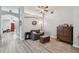 Comfortable living area with hardwood floors, neutral color scheme, and an archway leading to other rooms at 30918 Burleigh Dr, Wesley Chapel, FL 33543