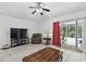 Well-lit living room with sliding glass doors and modern light-grey floors at 30918 Burleigh Dr, Wesley Chapel, FL 33543