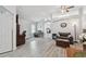 Spacious living room with wood floors, neutral tones, and an open layout to other rooms in the home at 30918 Burleigh Dr, Wesley Chapel, FL 33543
