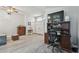 Versatile living space showing wood floors, a desk area, and plenty of natural light at 30918 Burleigh Dr, Wesley Chapel, FL 33543