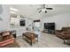 Open-concept living room and kitchen area with modern decor, ceiling fan, and neutral paint at 30918 Burleigh Dr, Wesley Chapel, FL 33543