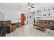 Comfortable living room with ceiling fan, sliding doors to the outside, and modern light-grey floors at 30918 Burleigh Dr, Wesley Chapel, FL 33543