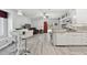 Open-concept kitchen and living area with modern furniture and a view to the back patio at 30918 Burleigh Dr, Wesley Chapel, FL 33543