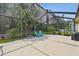 Spacious screened patio offers ample seating, backyard views, and features a grill, perfect for outdoor living at 30918 Burleigh Dr, Wesley Chapel, FL 33543