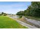 Scenic pond view bordered by lush greenery and well-maintained grass, offering a serene natural setting at 30918 Burleigh Dr, Wesley Chapel, FL 33543