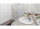 Clean bathroom featuring a double vanity, modern fixtures, and a shower with a clean white curtain at 30936 Summer Sun Loop, Wesley Chapel, FL 33545