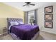 Relaxing bedroom featuring a comfortable bed, vibrant decor, and natural light from the window at 30936 Summer Sun Loop, Wesley Chapel, FL 33545