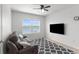 Cozy bedroom offering a beautiful lake view and a modern television for added comfort and entertainment at 30936 Summer Sun Loop, Wesley Chapel, FL 33545