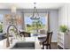 Charming dining area with chandelier and view of the water, creating an inviting atmosphere at 30936 Summer Sun Loop, Wesley Chapel, FL 33545