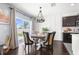 Cozy dining area with modern lighting, stylish decor, and sliding glass doors to the outdoor space at 30936 Summer Sun Loop, Wesley Chapel, FL 33545