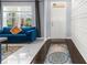 Inviting entryway with a blue sofa, white wainscoting, and a large window allowing natural light at 30936 Summer Sun Loop, Wesley Chapel, FL 33545
