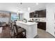 Open kitchen featuring an island with barstool seating, modern appliances, and stylish cabinetry, seamlessly flowing into the dining area at 30936 Summer Sun Loop, Wesley Chapel, FL 33545