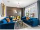 Bright living room with a wood accent wall, stylish seating, and large windows for natural light at 30936 Summer Sun Loop, Wesley Chapel, FL 33545