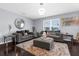 Cozy living room showcases plush sofas, an area rug, and an attractive mirror, creating a relaxing and inviting atmosphere at 30936 Summer Sun Loop, Wesley Chapel, FL 33545