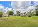 Wide backyard showing RV hookups, a shed, and a pickup truck on a large lawn with scattered trees at 3217 Mott Rd, Dover, FL 33527