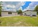 The backyard features green grass between two separate small buildings with a patio in between at 3217 Mott Rd, Dover, FL 33527