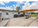 Backyard patio perfect for outdoor dining with a barbecue grill, table, chairs, and a bright umbrella at 3217 Mott Rd, Dover, FL 33527