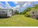 Spacious backyard featuring two RVs and a utility shed on a well-maintained lawn with mature trees at 3217 Mott Rd, Dover, FL 33527