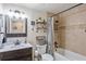 Charming bathroom showcasing a vanity, decorative shelves, and a bathtub with a shower at 3217 Mott Rd, Dover, FL 33527