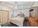 Cozy bedroom features a comfortable bed, a ceiling fan, and wooden furniture providing a restful retreat at 3217 Mott Rd, Dover, FL 33527