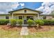 Inviting front porch with seating and charming details, enhances curb appeal at 3217 Mott Rd, Dover, FL 33527