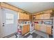 Functional kitchen with ample cabinet space, white appliances, and a door to the backyard at 3217 Mott Rd, Dover, FL 33527