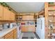 Functional kitchen with ample cabinet space, white appliances, and a cozy, vintage feel at 3217 Mott Rd, Dover, FL 33527