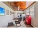 Functional laundry room with modern appliances, wood ceiling and a comfortable seating arrangement at 3217 Mott Rd, Dover, FL 33527