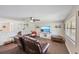 Cozy living room with a ceiling fan and media center, great for entertaining at 3217 Mott Rd, Dover, FL 33527