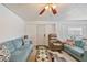 Inviting living room featuring comfortable couches, a ceiling fan, and stylish decor for a cozy atmosphere at 3217 Mott Rd, Dover, FL 33527
