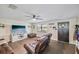 Open living room with laminate flooring, TV, and neutral decor at 3217 Mott Rd, Dover, FL 33527