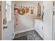 Cozy mudroom featuring stylish patterned floors, white storage cabinets, and convenient wall hooks at 3217 Mott Rd, Dover, FL 33527