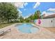Inviting pool and spa with a brick surround creating a backyard oasis for relaxation and enjoyment at 3217 Mott Rd, Dover, FL 33527