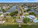 Aerial view of waterfront home with private dock, lush green lawn, and easy access to the scenic canal at 3226 Gardenia Dr, Hernando Beach, FL 34607
