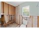 Bathroom under construction showing the toilet and framed walls and a small window at 3226 Gardenia Dr, Hernando Beach, FL 34607